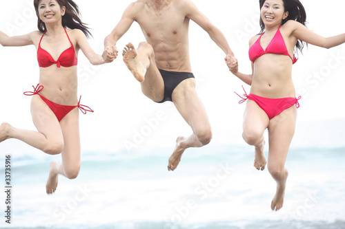 ビーチで遊ぶ水着姿の男女 Stock Photo Adobe Stock