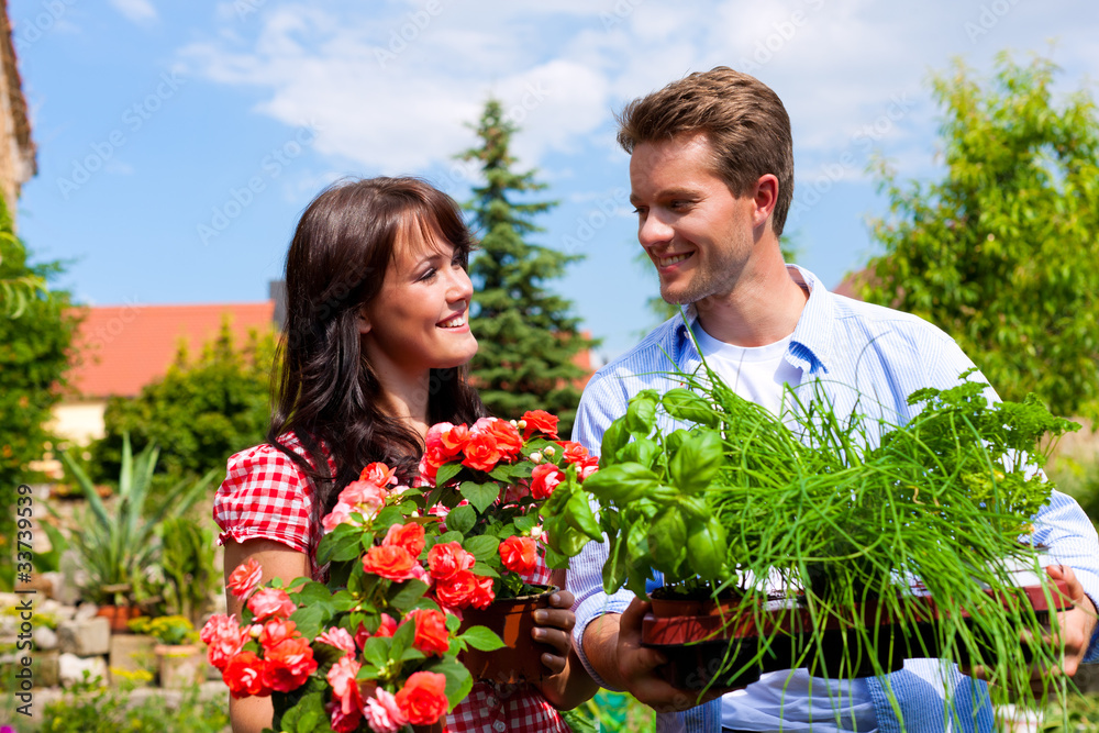 Gardening in summer - couple with herbs and flowers