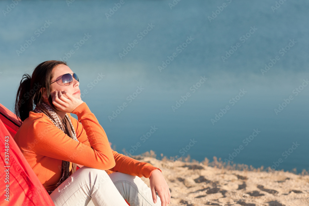 Camping beach woman by campfire in tent