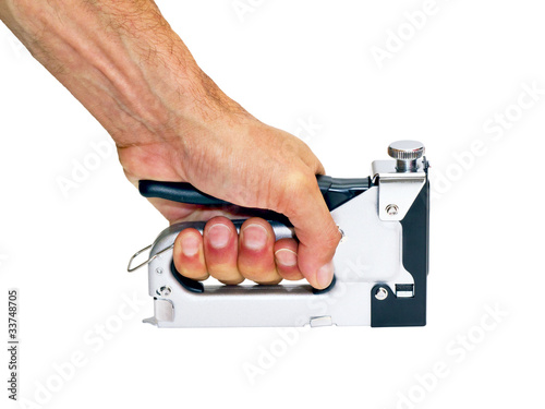 staple gun  in the man's hand