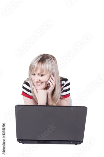 Girl with notebook talking on the mobile