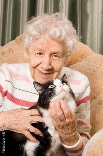 The grandmother with a cat on a sofa
