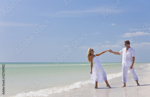 Happy Young Couple Dancing Holding Hands on A Tropical Beach