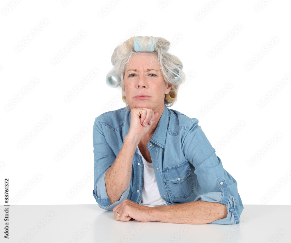 Portrait of senior woman with hair curlers