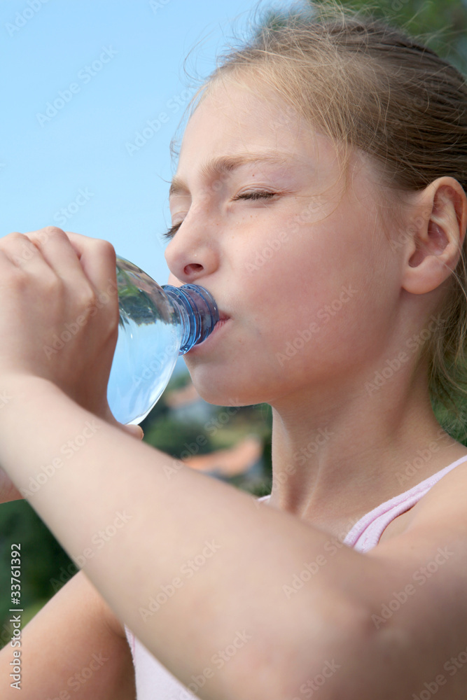 Portrait of young girl drinking water from bottle Portrait of young girl drinking water from bottle