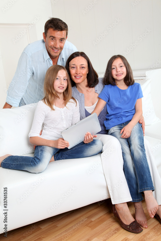 Parents and children using electronic tablet at home Parents and children using electronic tablet at home