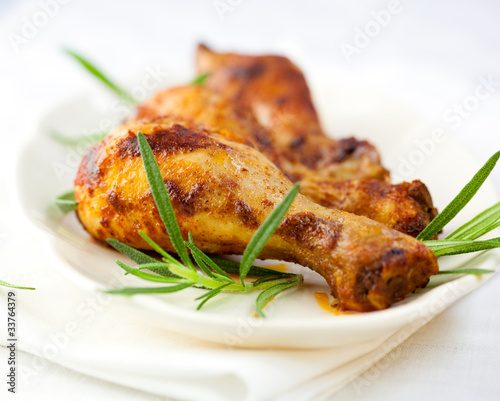 Roasted chicken legs with rosemary sprigs