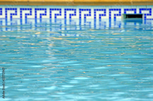 blue water of the pool and mosaic border