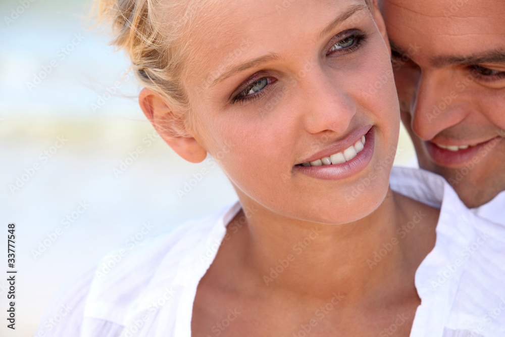 blonde woman hugged tenderly from the back by her partner blonde woman hugged tenderly from the back by her partner