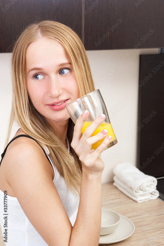 Portrait of beautiful relaxed young woman standing at the kitche Portrait of beautiful relaxed young woman standing at the kitche