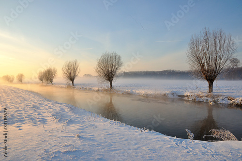 Dutch winter landscape with snow and low sun