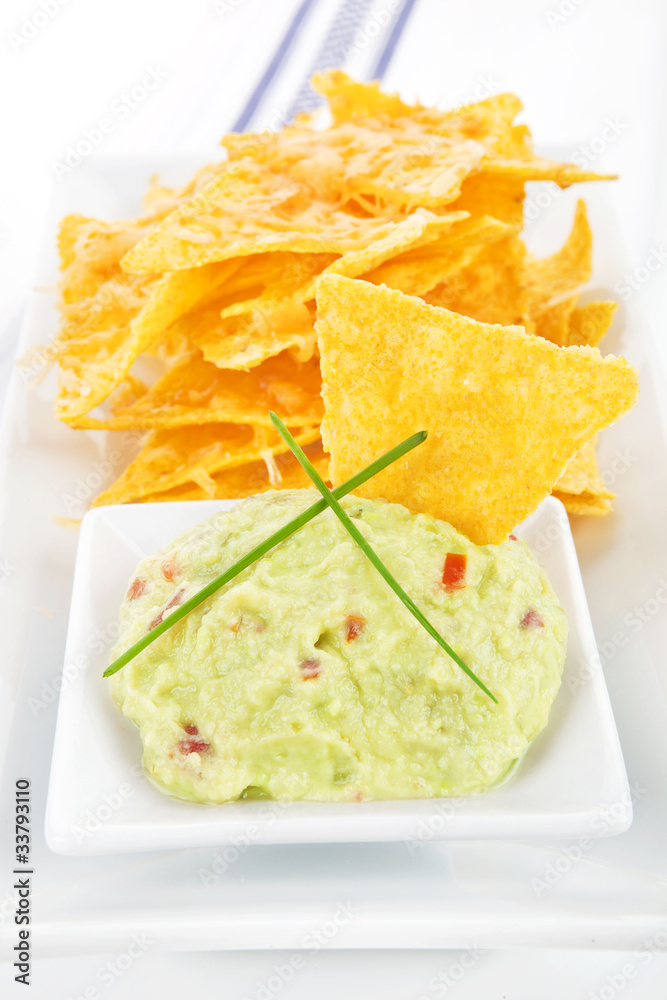 Nachos with guacamole dip. Nachos with guacamole dip.