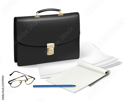 A briefcase and notebook and some office supplies.