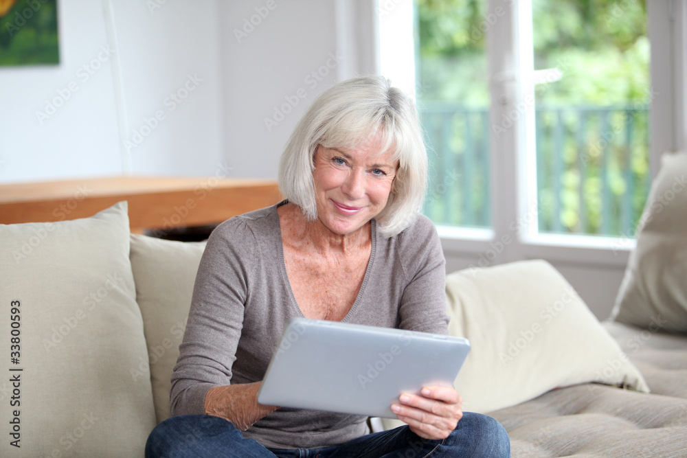 Porrtait of senior woman using electronic tablet at home Porrtait of senior woman using electronic tablet at home