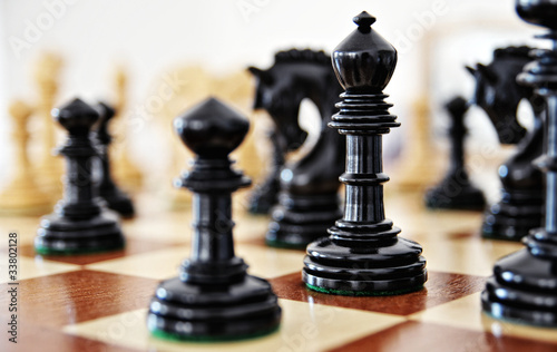 Chess pieces on wood board photo