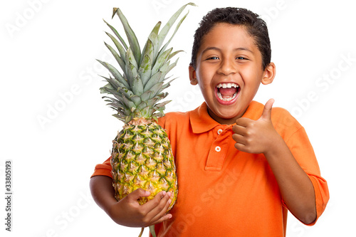 Child Smiling and Holding Pineapple with Thumb Up