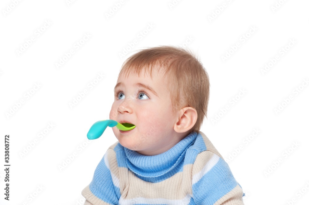 Baby boy holding spoon in his mouth Baby boy holding spoon in his mouth