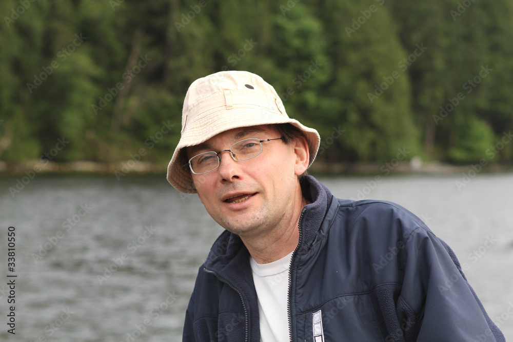 Man looking sarcastically wearing glasses on a shore