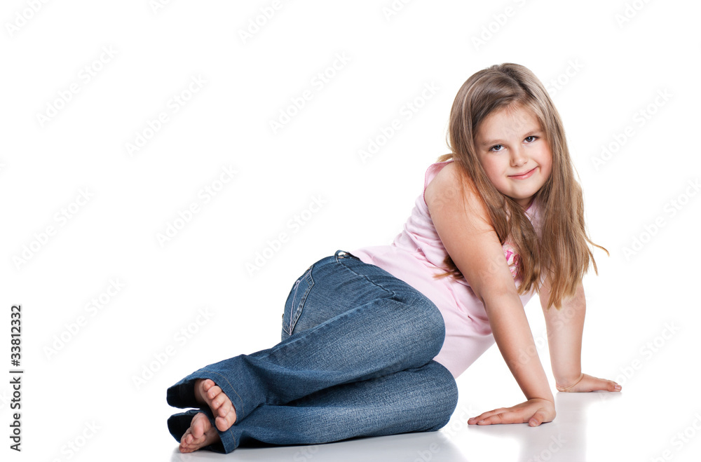 Cute happy little girl sitting on white background