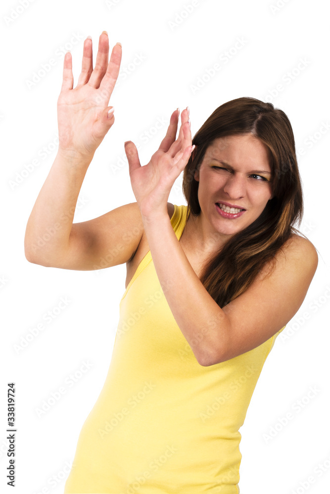 Young woman in a yellow dress protecting her face Young woman in a yellow dress protecting her face