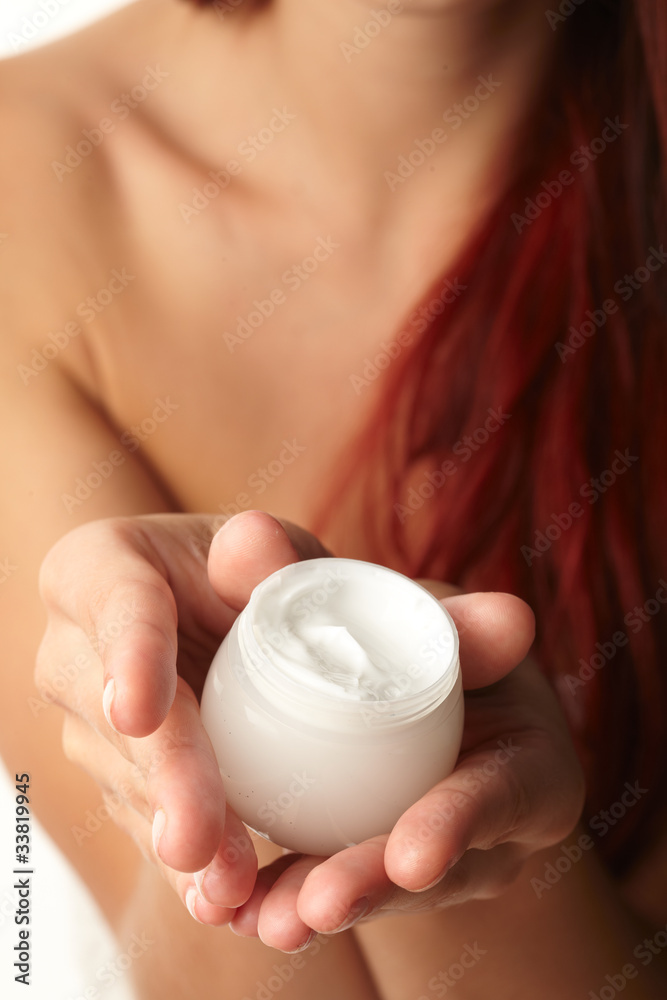Woman applying cream on her hand Woman applying cream on her hand