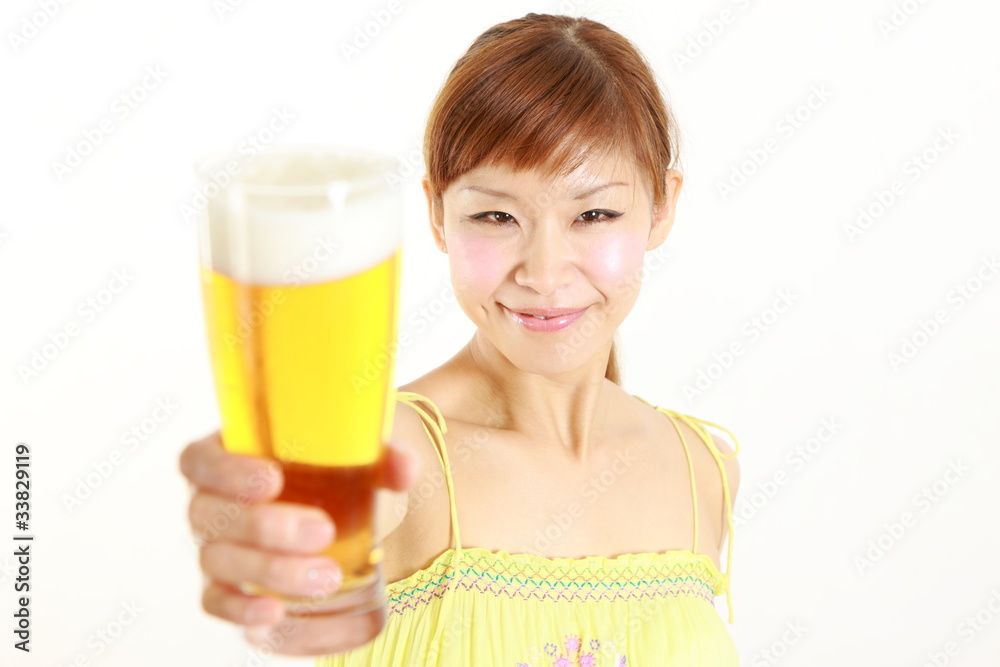 young japanese woman with a glass of beer young japanese woman with a glass of beer