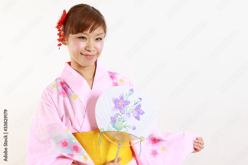 Young woman wearing Japanese kimono with round paper Fan Young woman wearing Japanese kimono with round paper Fan