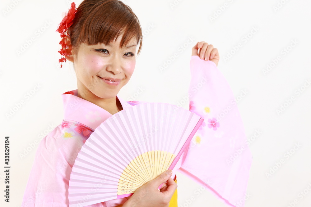Young woman wearing Japanese kimono with paper Fan Young woman wearing Japanese kimono with paper Fan