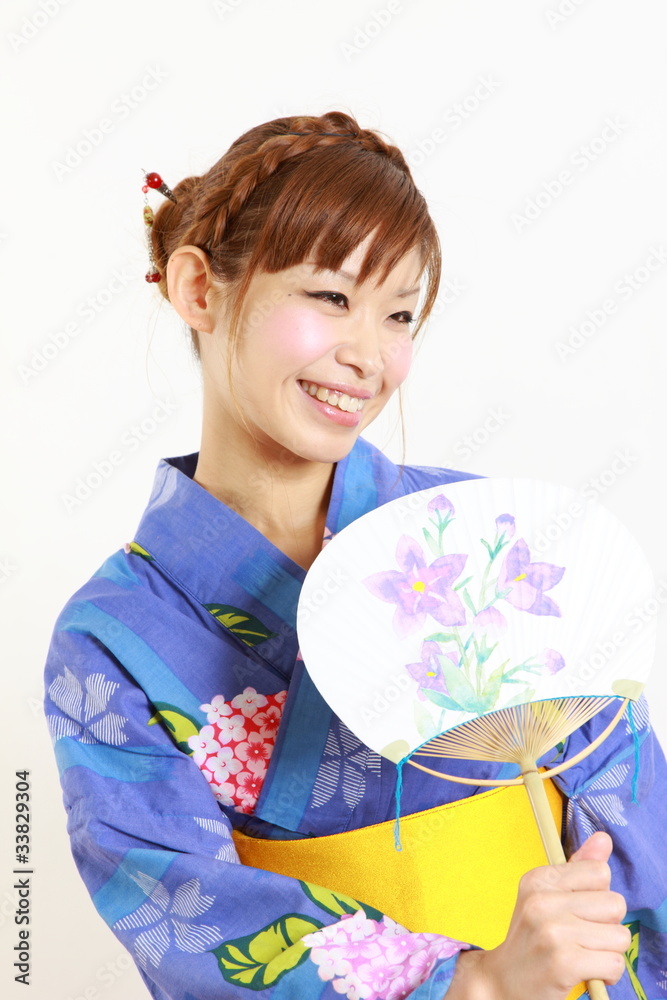 Young woman wearing Japanese kimono with round paper Fan Young woman wearing Japanese kimono with round paper Fan