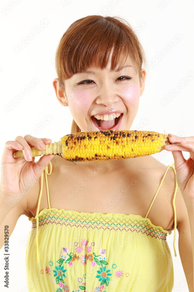 young japanese woman with grilled corn