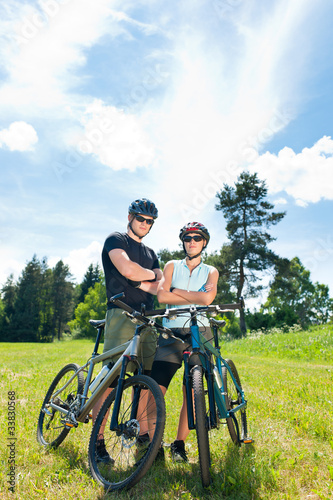 Sport mountain biking couple relax in meadows