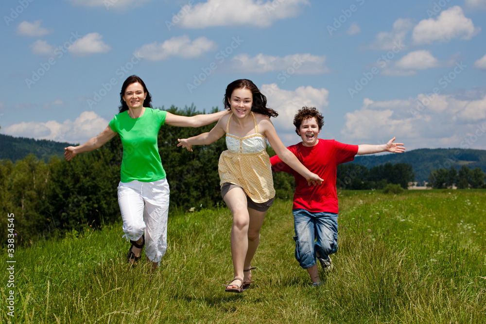 Active family - mother and kids running outdoor Active family - mother and kids running outdoor
