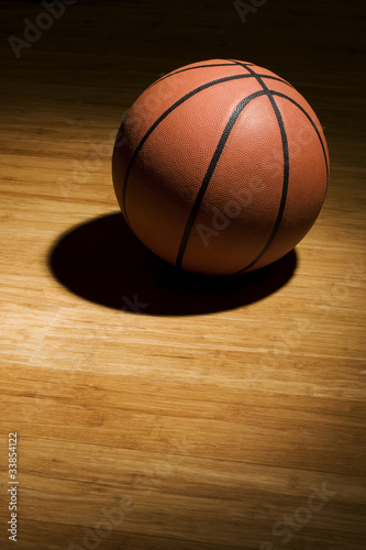 Basketball sitting on wood floor © fotopak