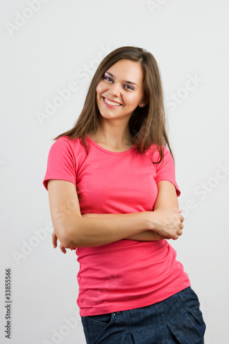 Confident woman with arms crossed against