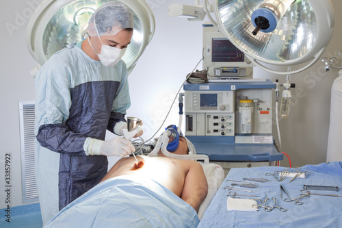 Male doctor performing operation