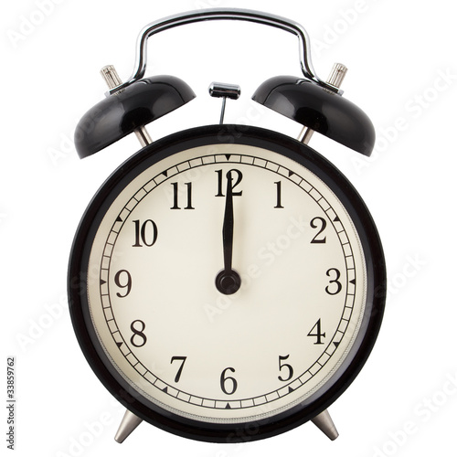 Old Alarm Clock in black and white, showing twelve o'clock.