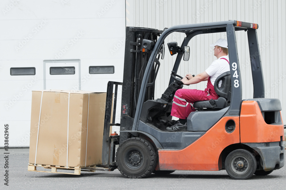 warehouse worker driver in forklift