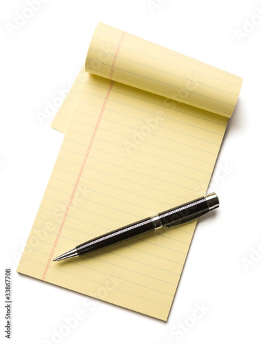 Pen on opened note pad isolated on white background