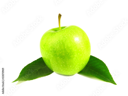 Green apple between leaves