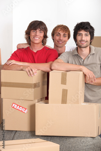 Three lads with packing boxes