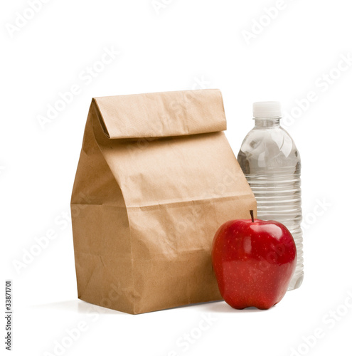 Canvas-taulu Brown lunch bag, red apple and bottle of water isolated on white