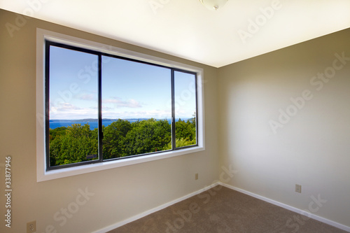 Empty white room with a large window