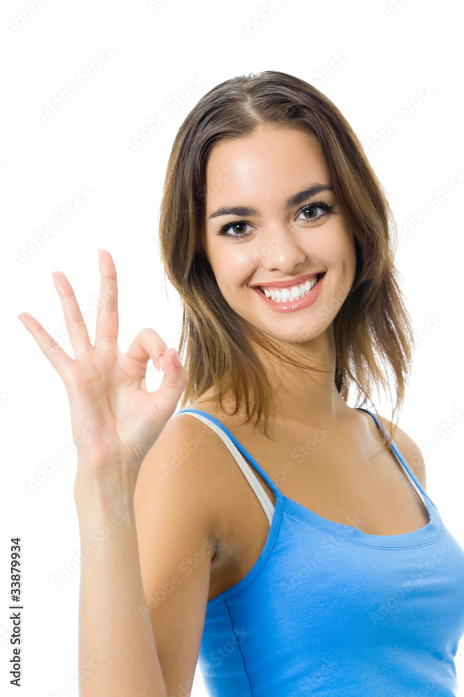 Young woman in sports wear showing OK gesture, isolated Young woman in sports wear showing OK gesture, isolated
