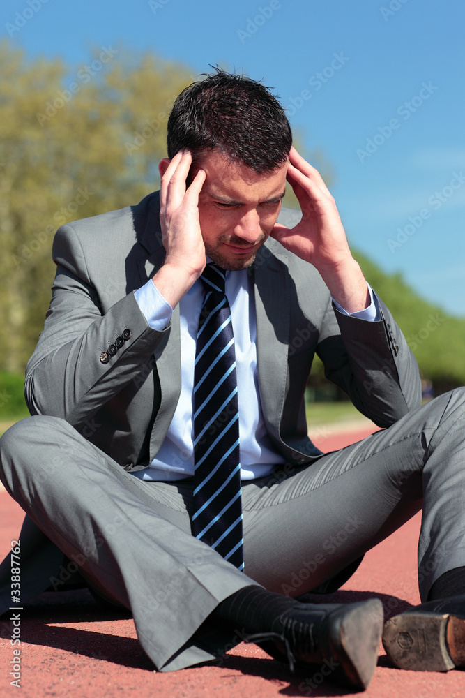 young businessman with head in the hands young businessman with head in the hands
