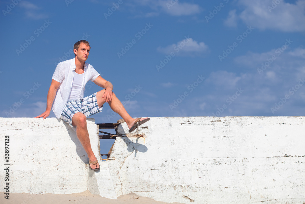 Man Sitting on Wall