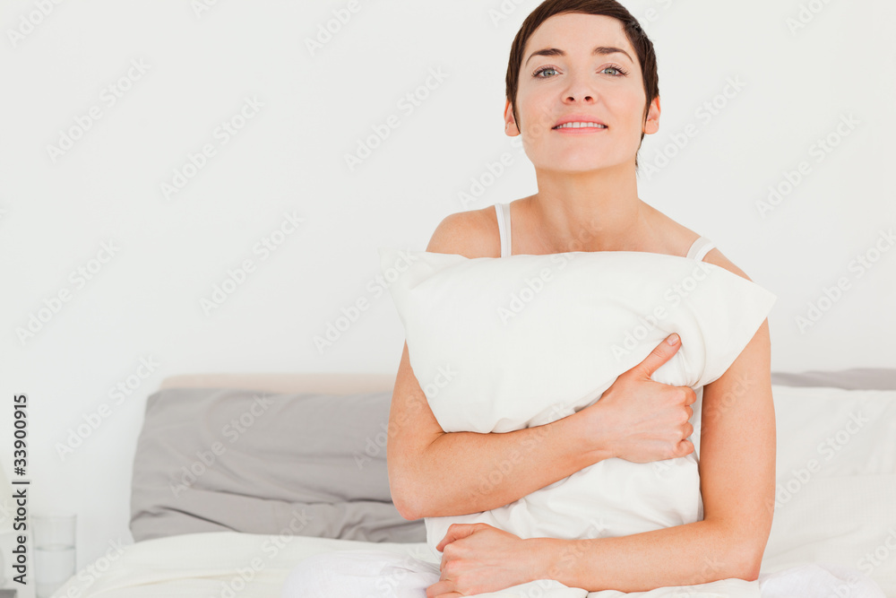 Charming woman holding a pillow Charming woman holding a pillow