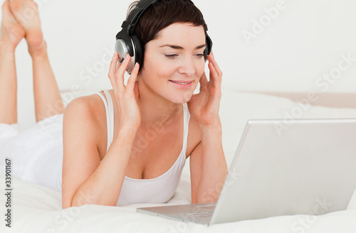 Close up of a cute woman watching a movie with her laptop