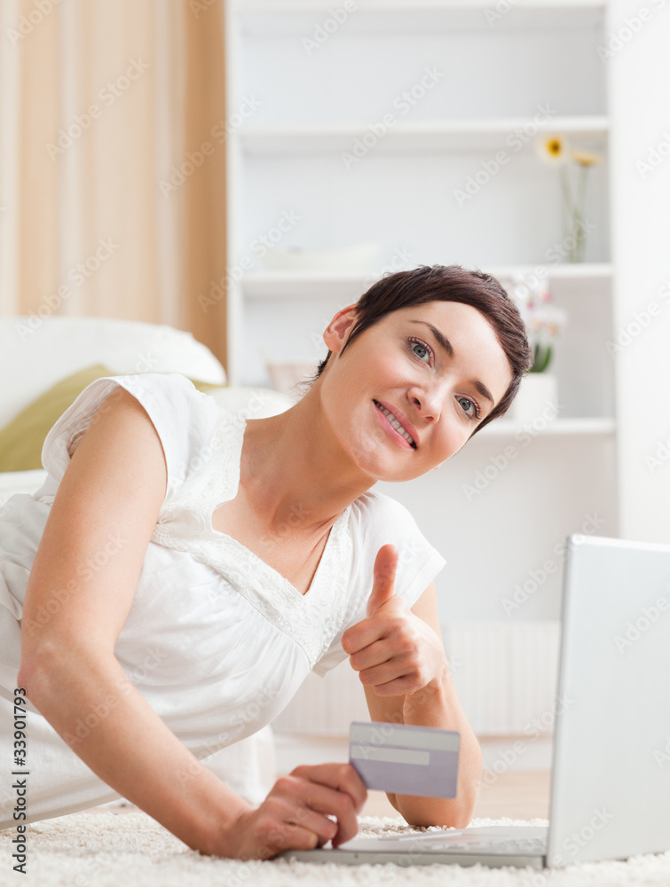 Portrait of a joyful brunette shopping online Portrait of a joyful brunette shopping online