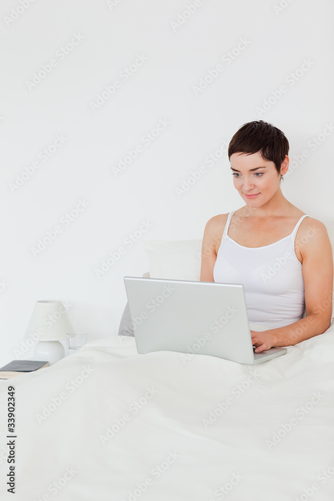 Portait of a brunette woman using a laptop Portait of a brunette woman using a laptop