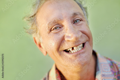 Canvas Print aged toothless man smiling at camera